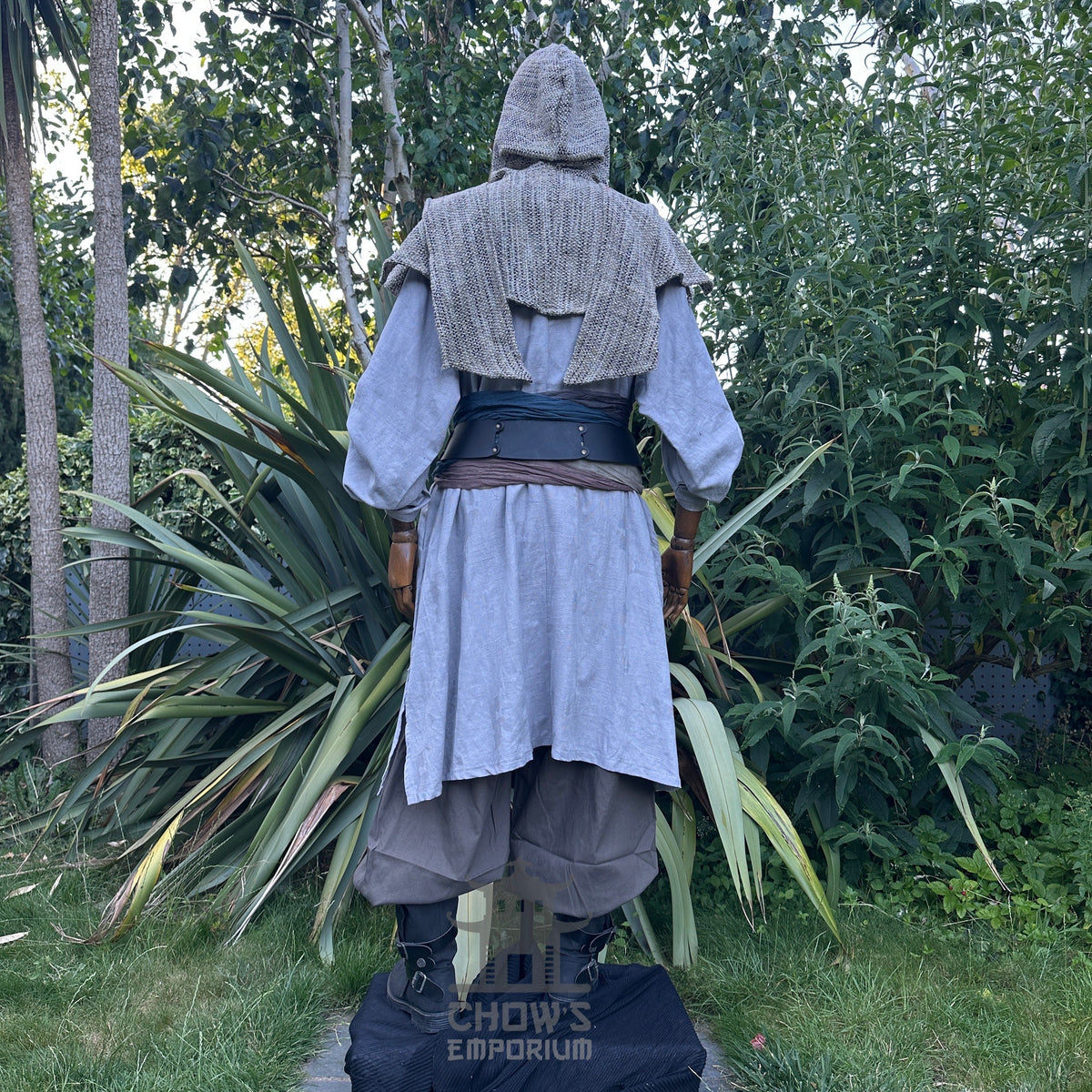 Medieval LARP outfit back view, featuring a grey cotton tunic, wrap around hood, trousers and sash.