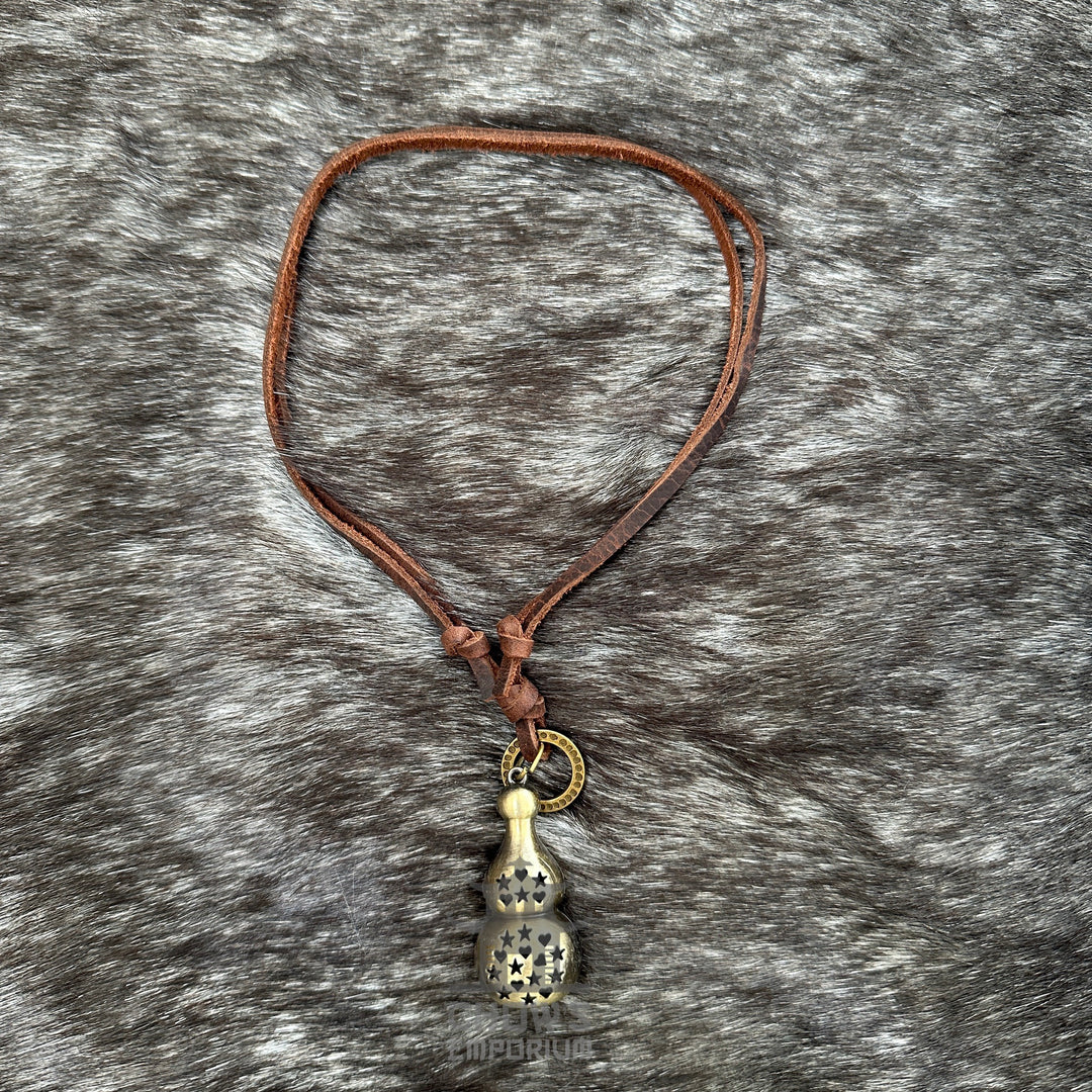 Medieval LARP lucky gourd necklace with brown leather cord on fur backdrop.