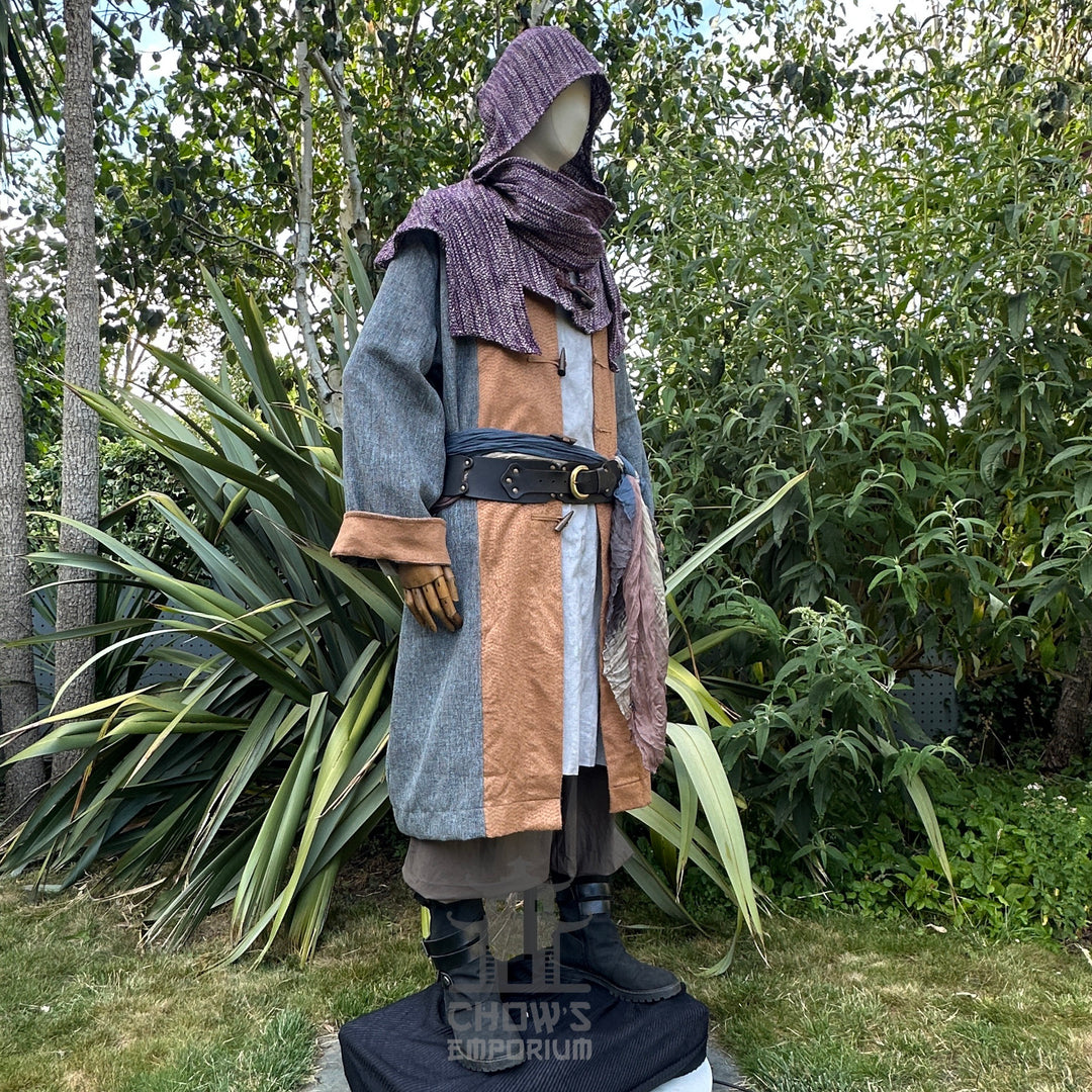 Medieval LARP costume side view, featuring a pirate coat in teal and brown, cotton tunic, wool.