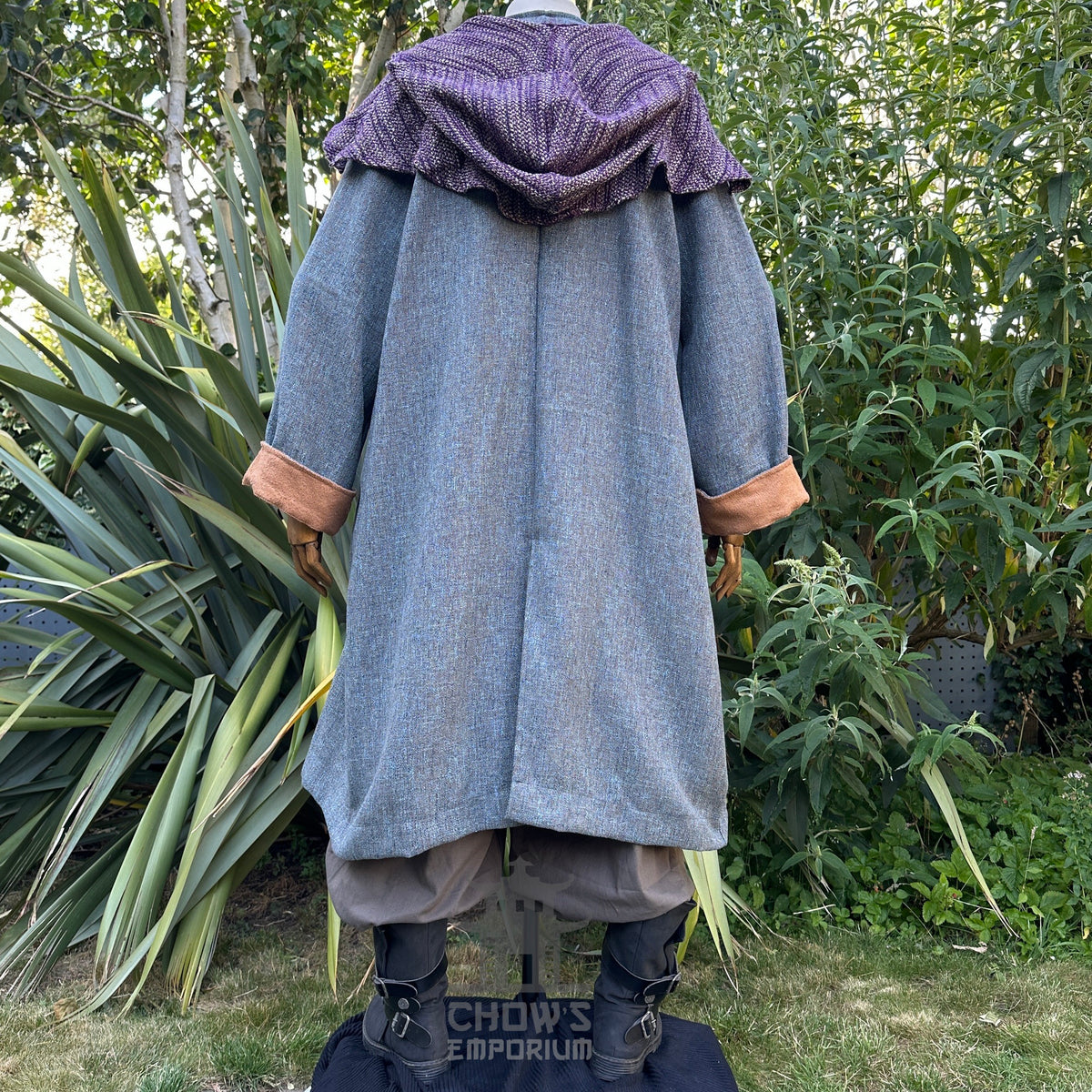 Rear view of medieval cleric robe, purple hood, brown cuffs.