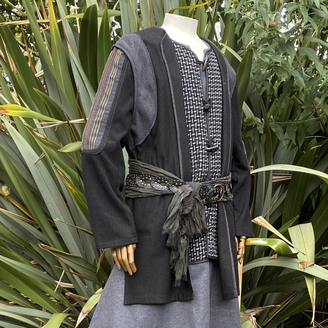 ornate panel medieval jacket in black and grey with braided trim.