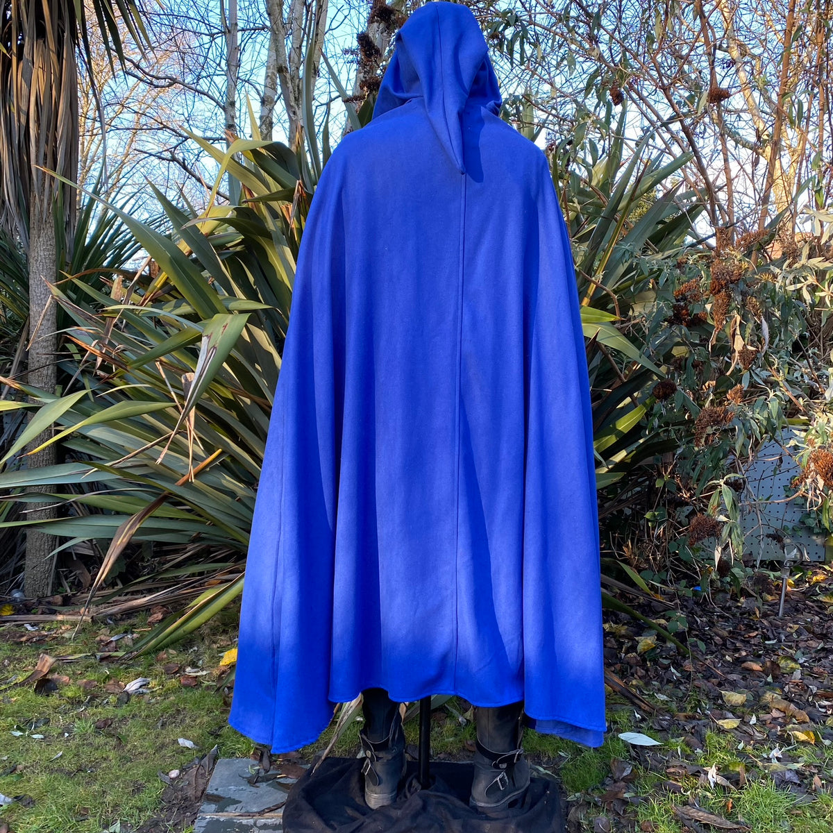 Back view of blue cloak with hood in garden setting for LARP.