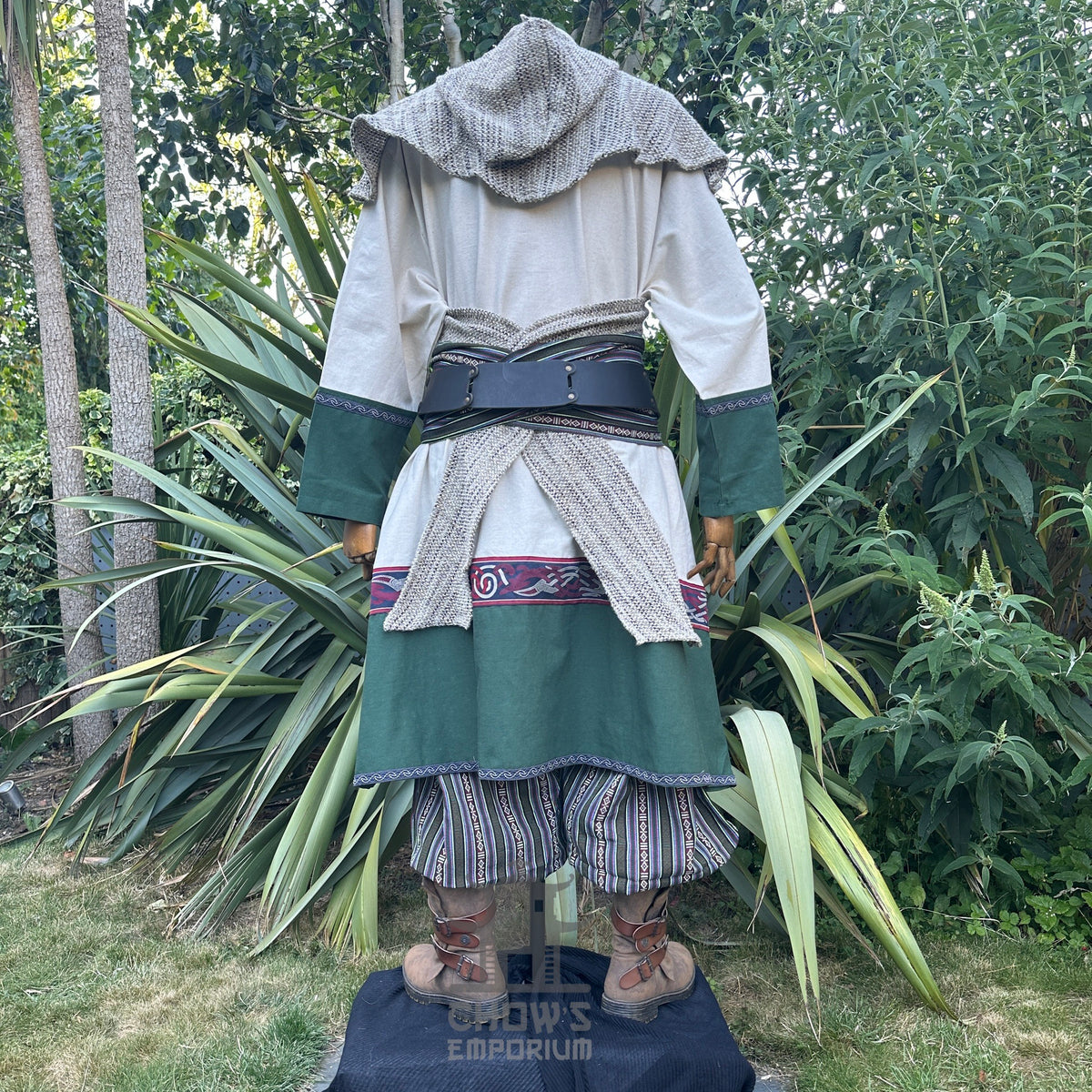 Rear view of medieval LARP outfit with striped trousers and draped hood.