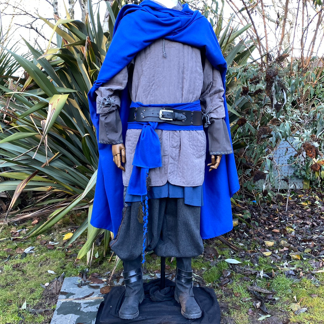 Royal blue Viking cloak draped on mannequin in garden for medieval LARP.