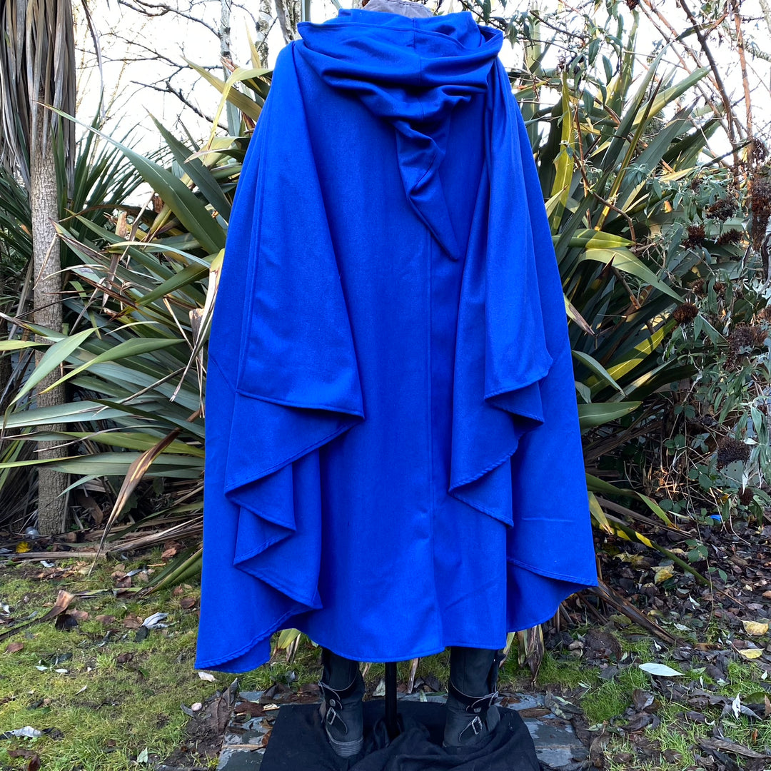 Back view of royal blue medieval LARP cloak draping over boots.