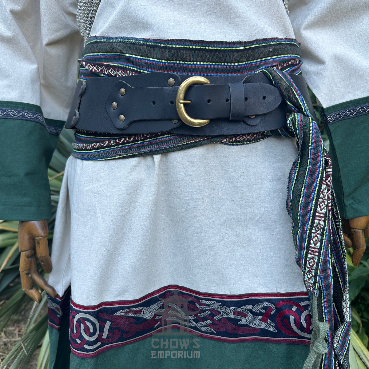 Medieval LARP outfit with green sleeves, black belt, and patterned sash.