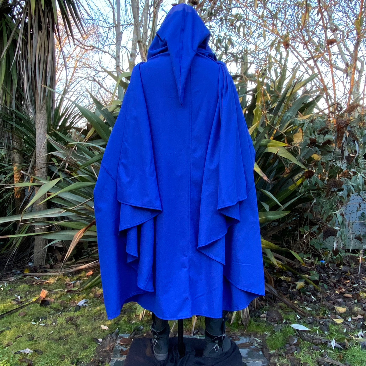 Back view of blue hooded cloak against woodland for LARP.