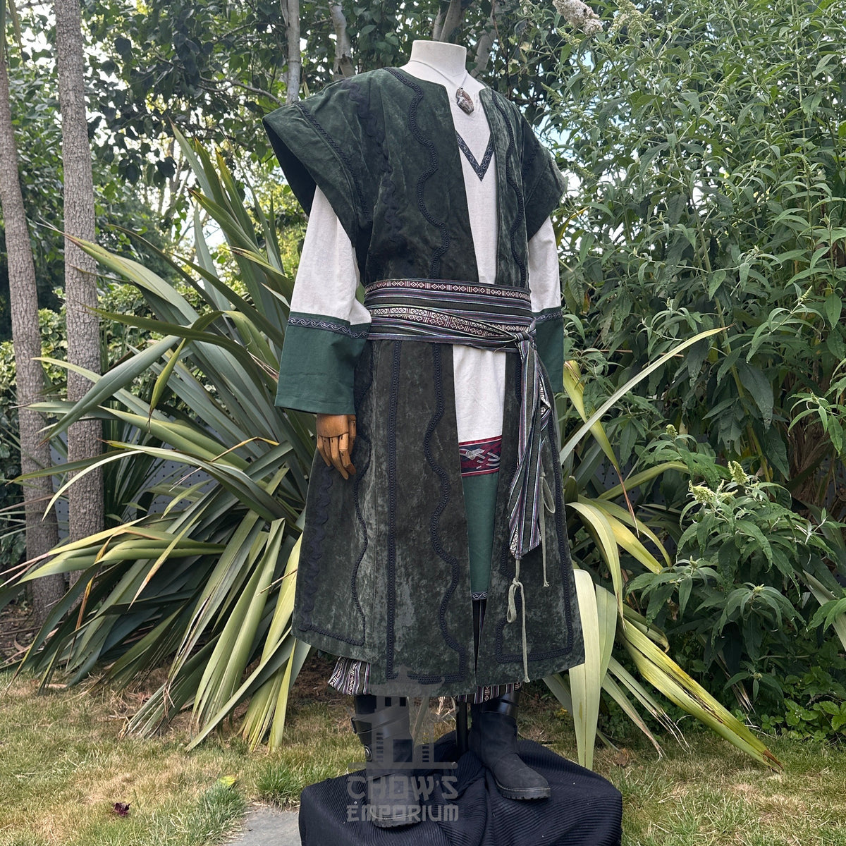 Medieval LARP costume side view featuring waistcoat, tunic, pants, belt and sash.