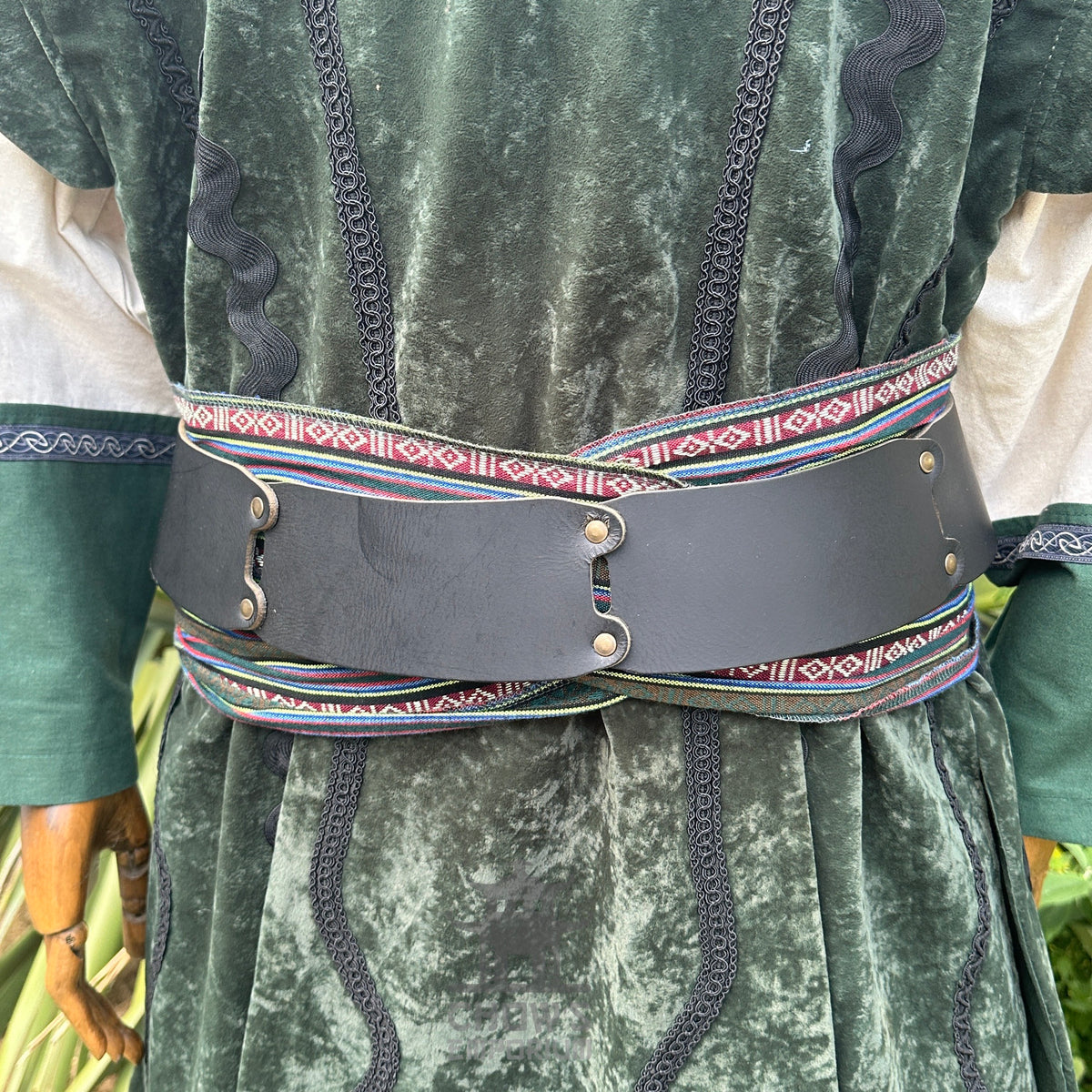 Emerald velvet Viking LARP waistcoat with black belt and patterned sash.