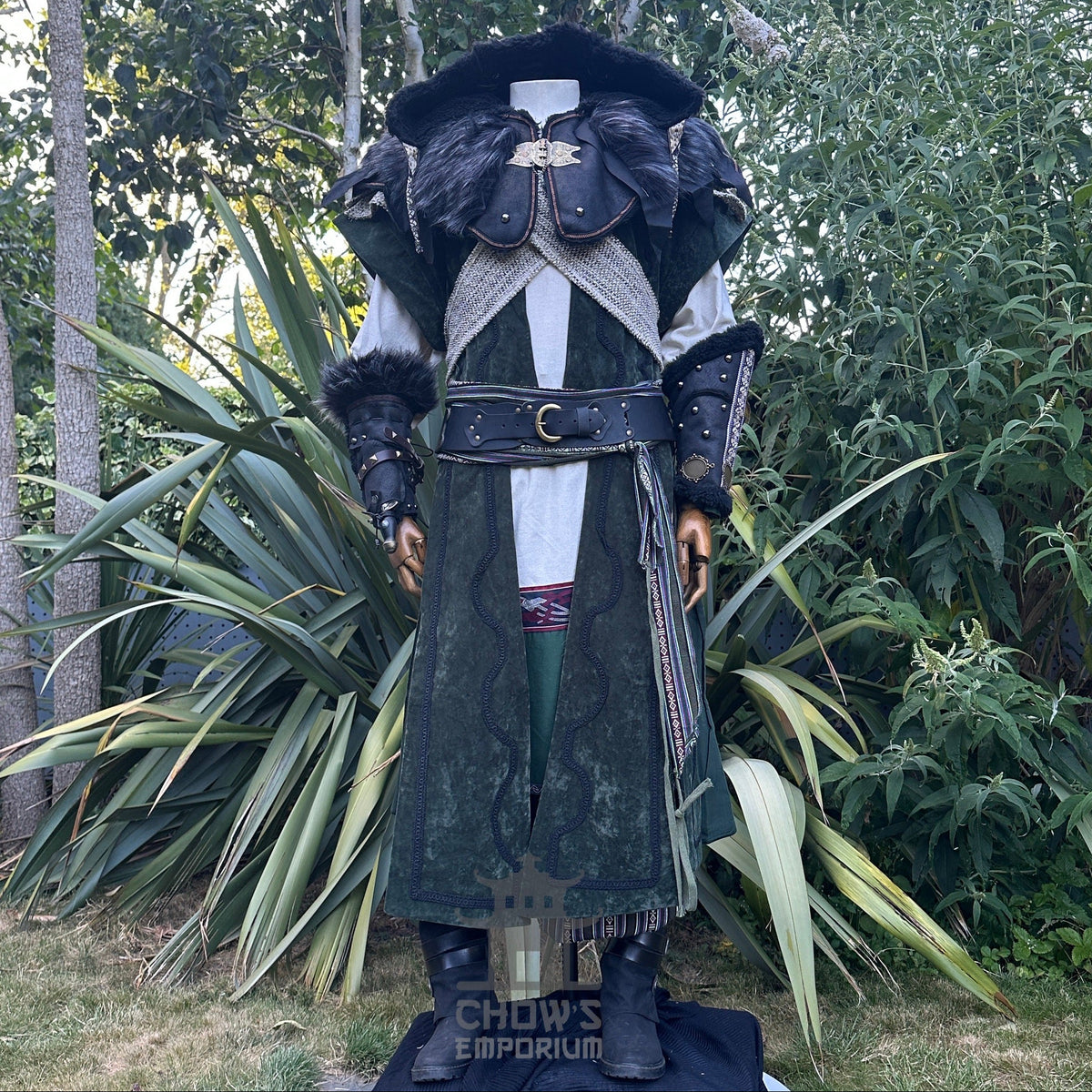 Medieval LARP costume front view featuring a long green waistcoat, black faux leather hood and vambraces. For Renaissance Faire and historical roleplay events.