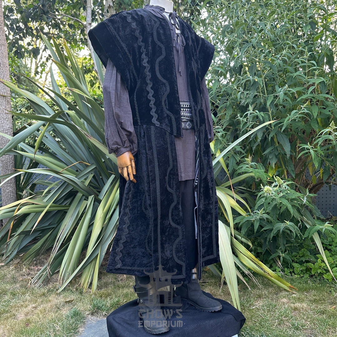 Medieval LARP costume side view featuring a black suede-effect waistcoat, grey shirt, and sash.