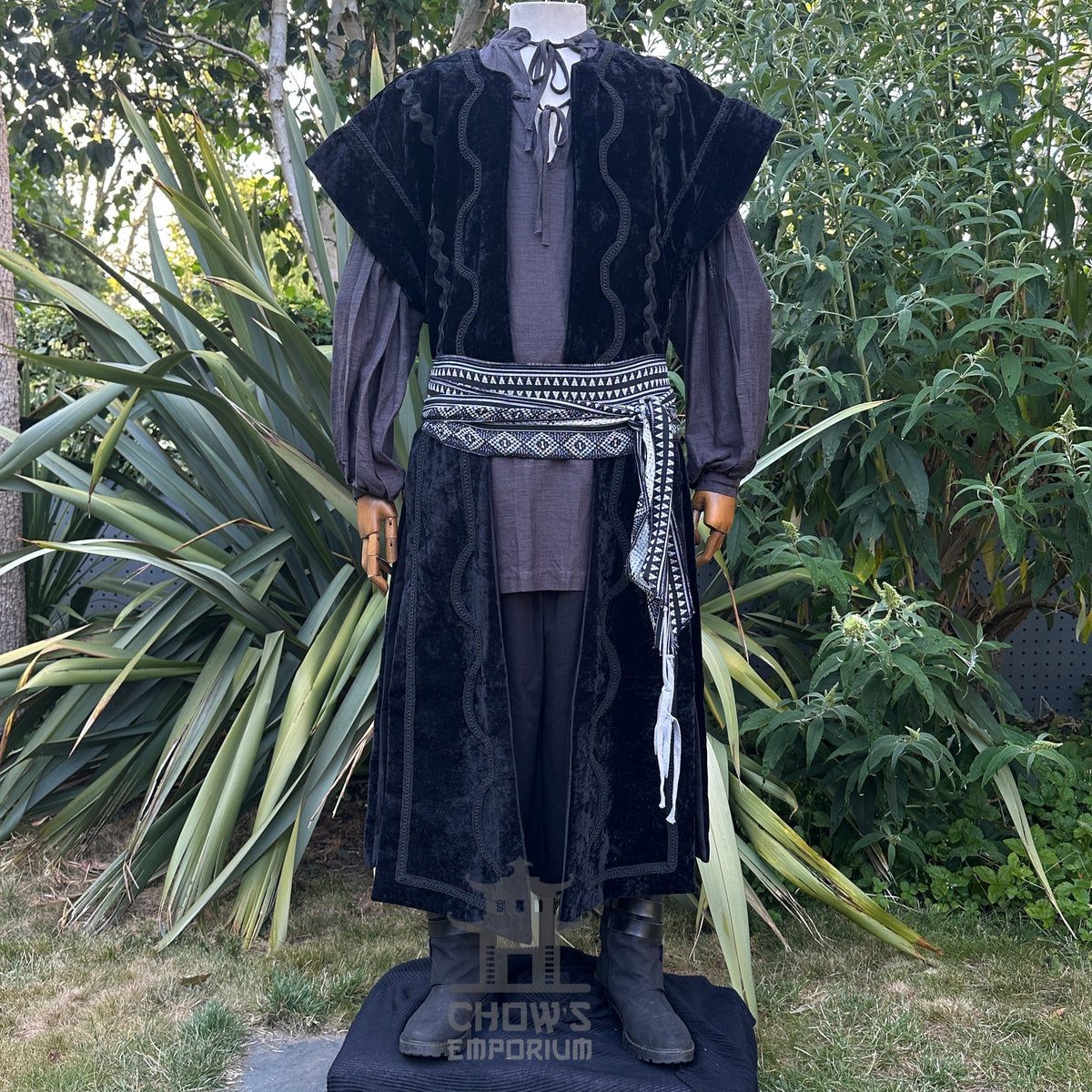 LARP costume with black velvet waistcoat and patterned sash.