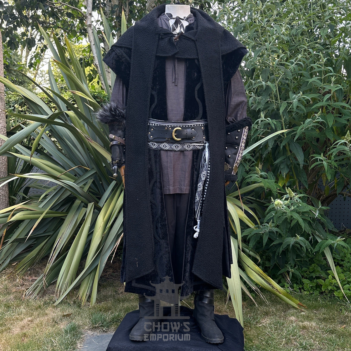 Medieval LARP costume front view featuring waistcoat, hood, vambraces, shirt, trousers, and sash.