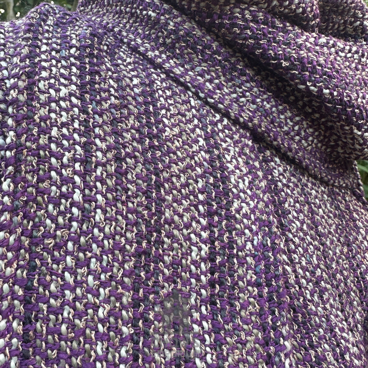 Purple and black woven fabric of medieval LARP hood, close-up view.