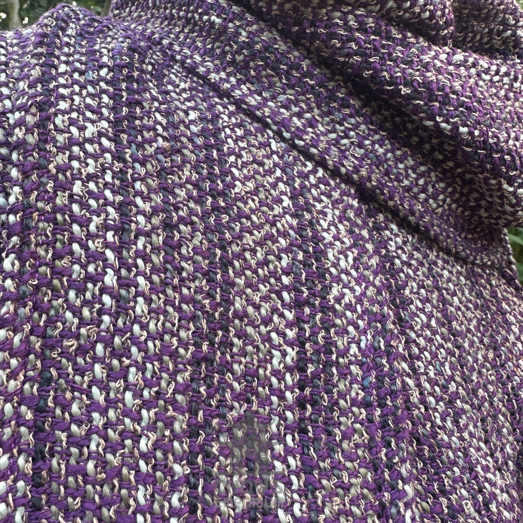 Purple and black woven fabric of medieval LARP hood, close-up view.
