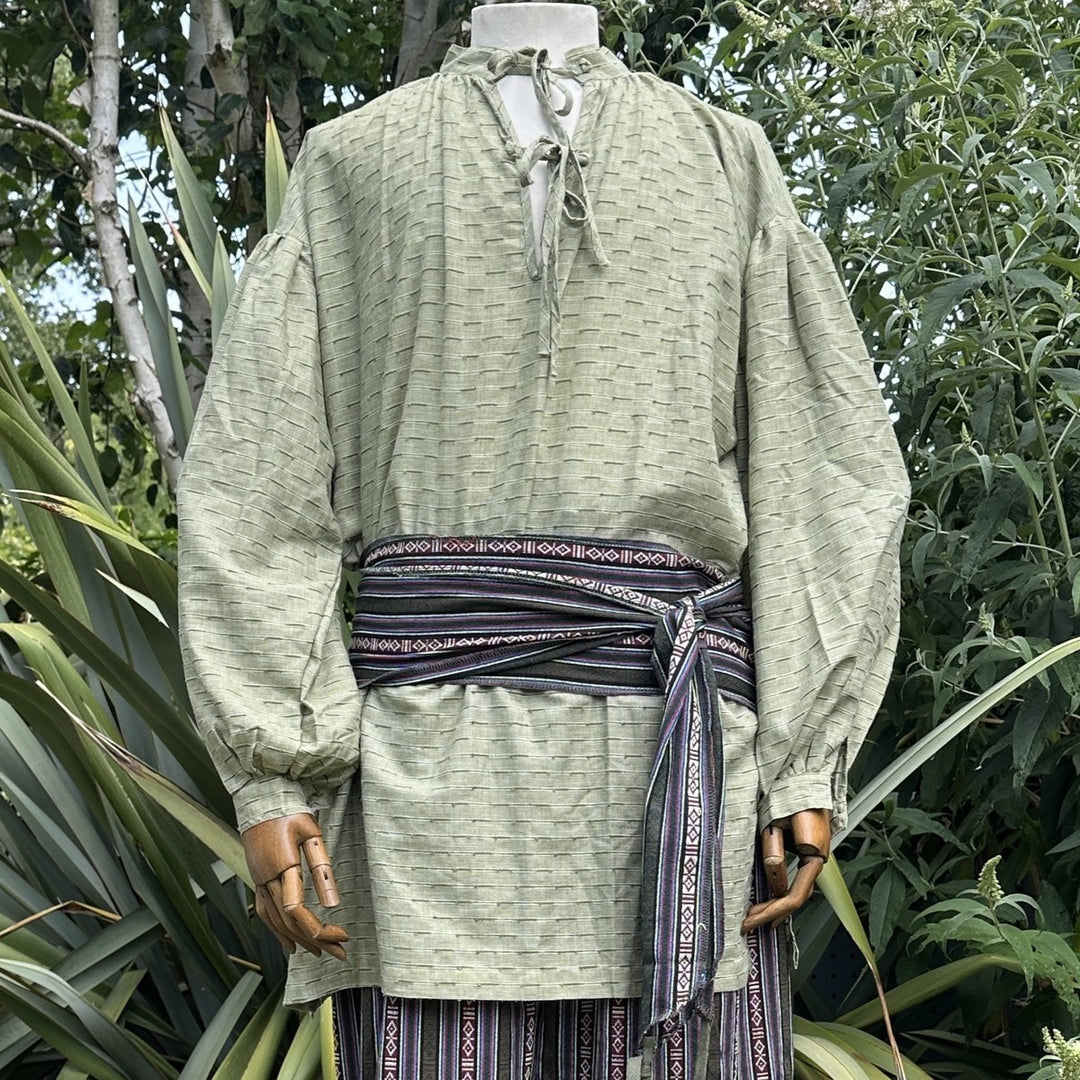 Green medieval LARP outfit with striped pants and sash, front view.