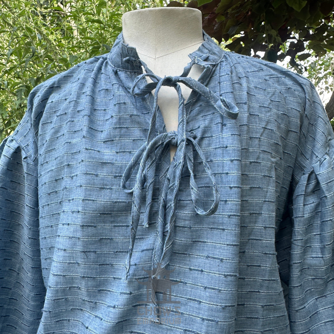 Blue LARP medieval shirt with zigzag pattern, close-up view.