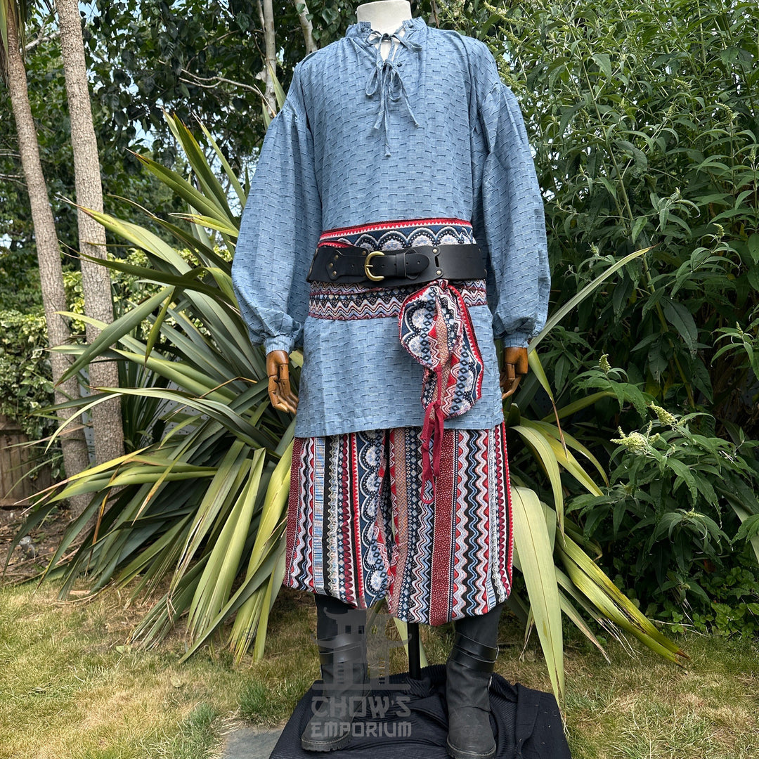 Medieval LARP shirt in blue cotton linen, side garden display with belt.