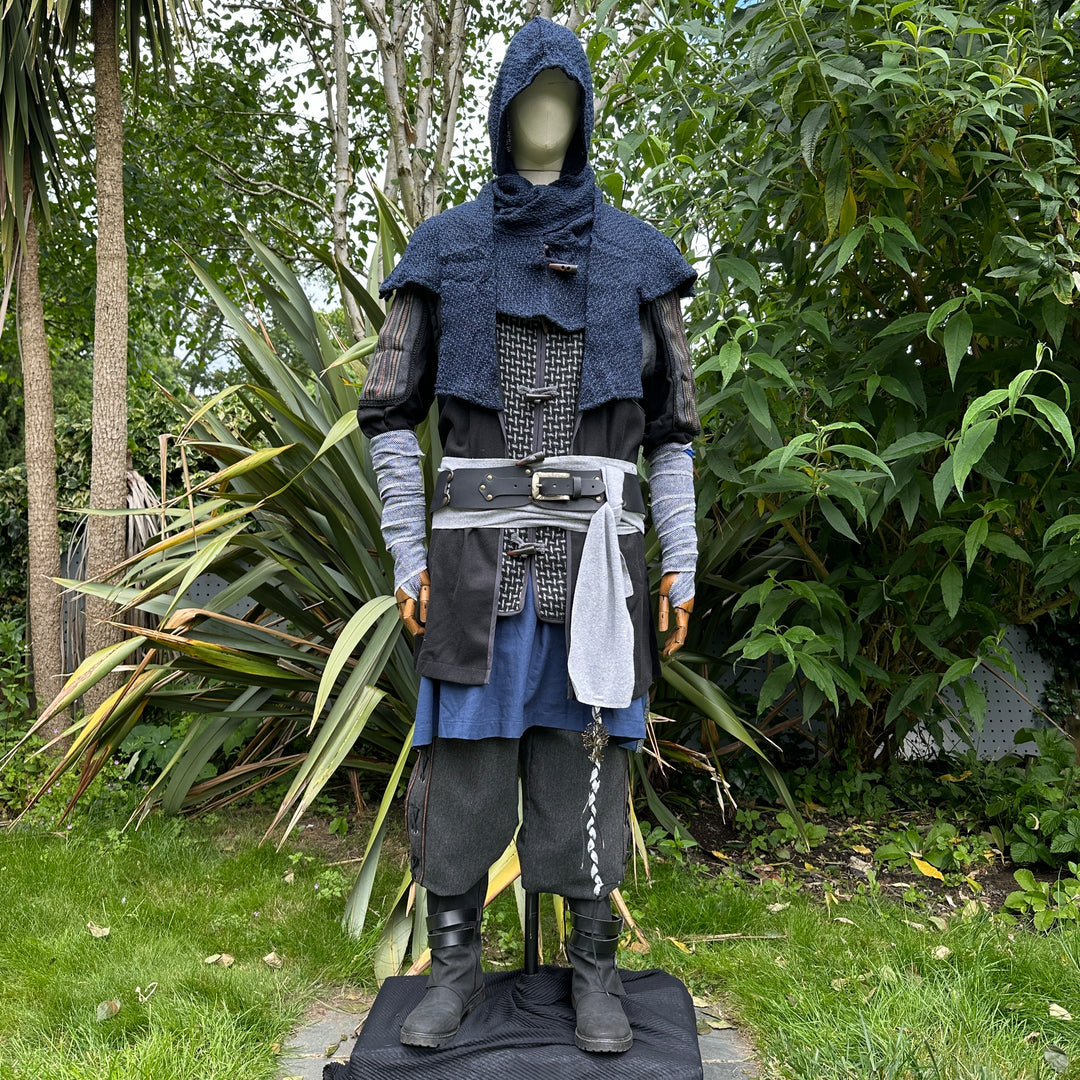 Medieval LARP druid attire outdoors with layered tunic and blue hood.