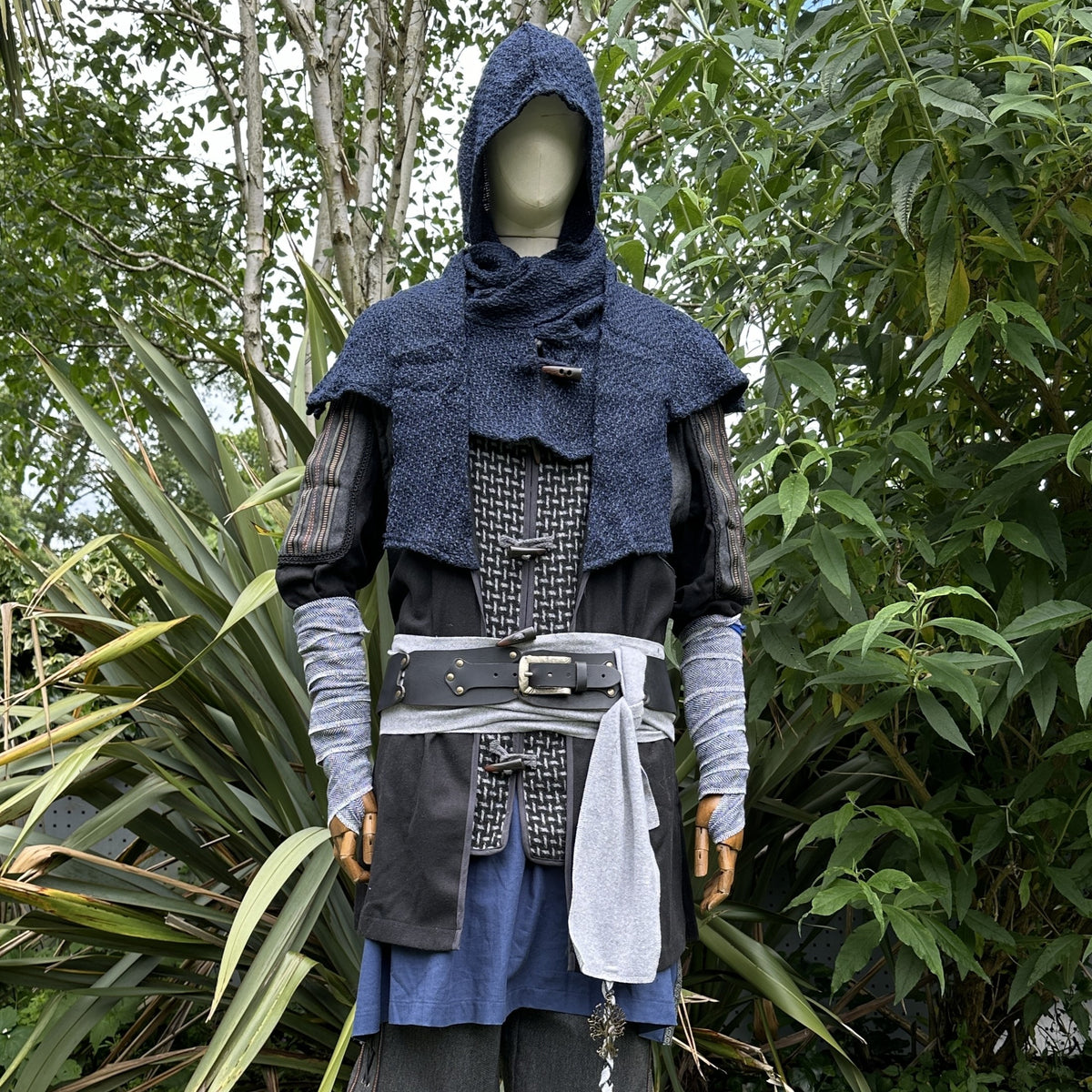 Medieval LARP costume with blue hood and belt.