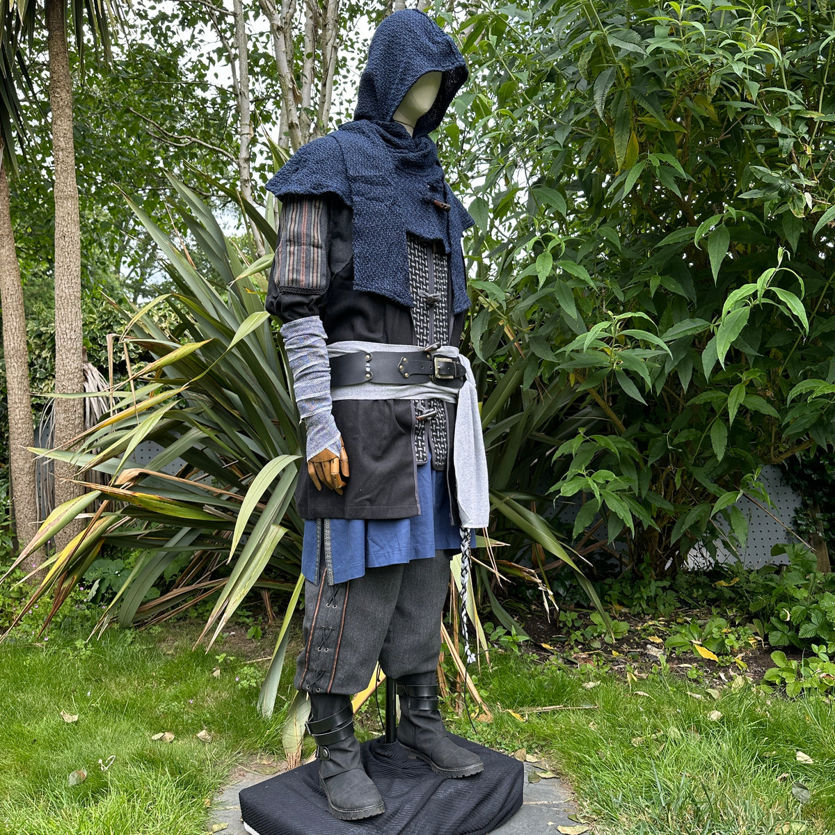 LARP medieval outfit, side view with hooded jacket and layered blues.
