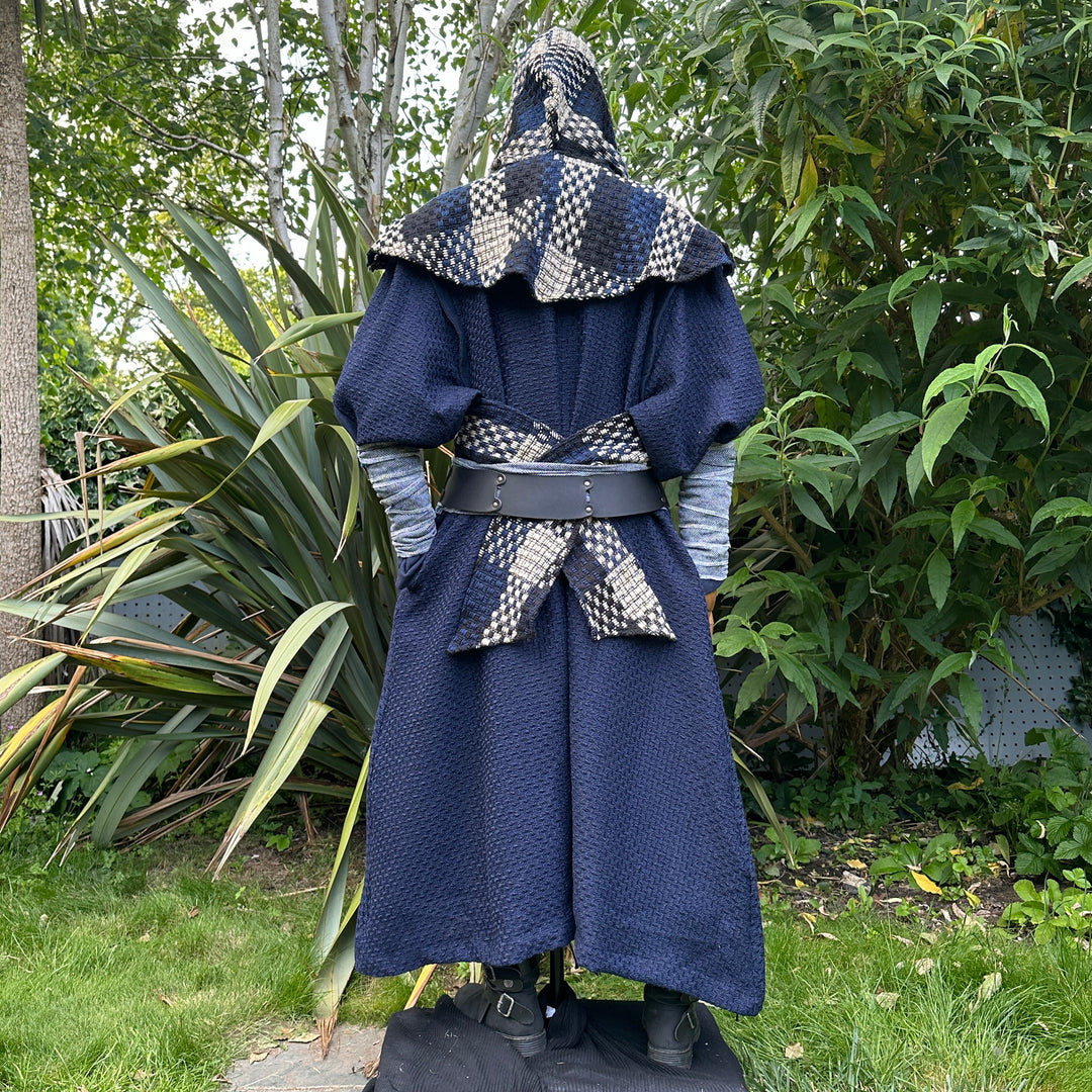 Blue and white check wool scarf hood over medieval-style cloak, back view.
