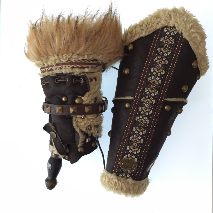 Brown leather and fur vambraces with metal studs for LARP medieval gear.