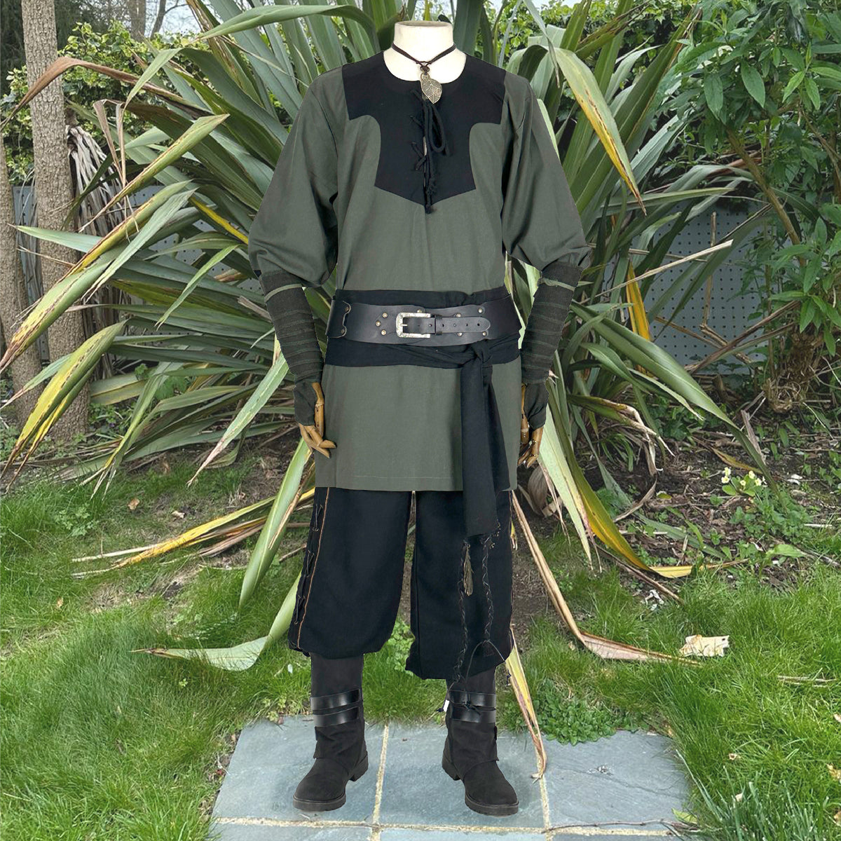 Medieval LARP outfit front view, featuring a green and black viking tunic, arm wraps, trousers.