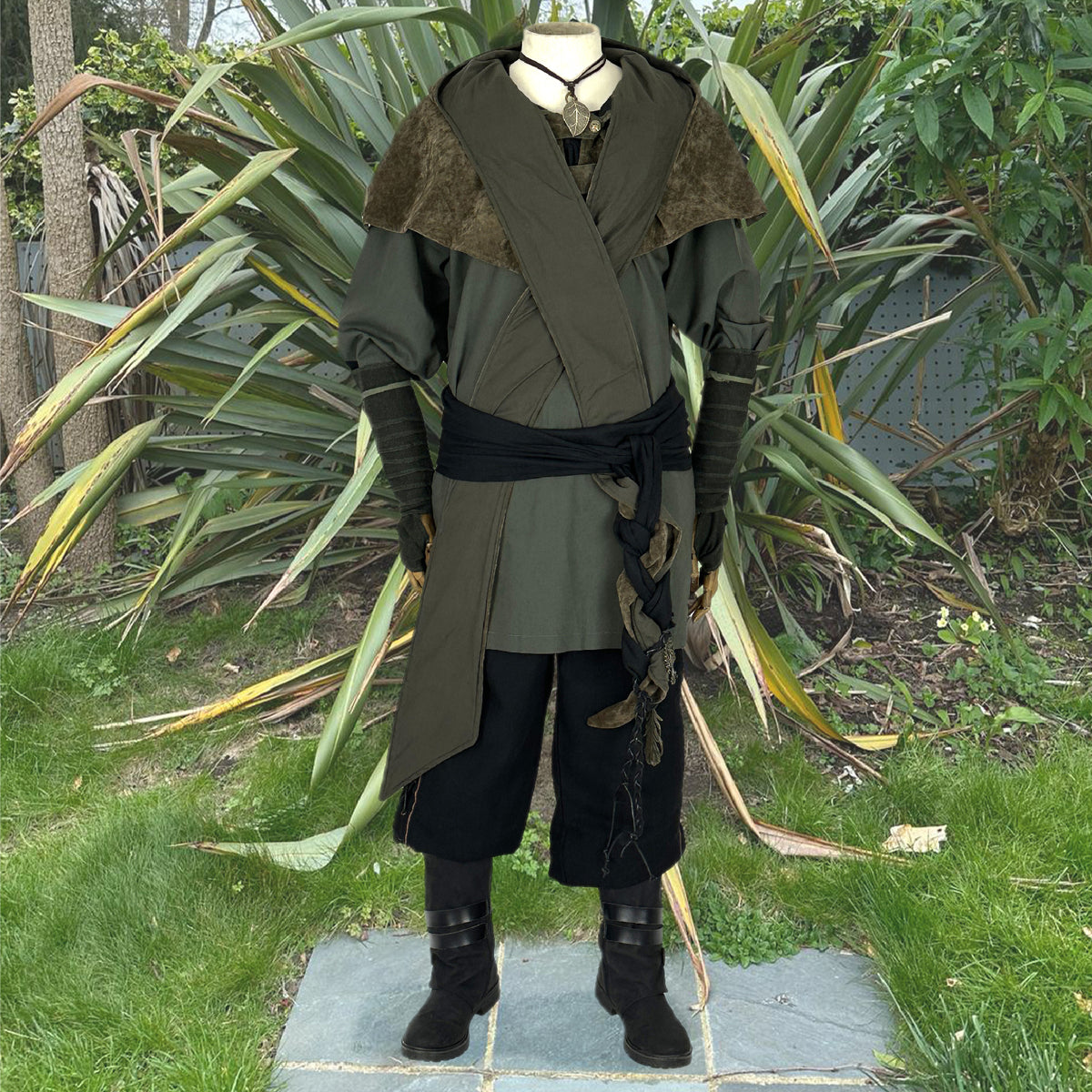 5 piece costume with hood and shirt in green, and black trousers.