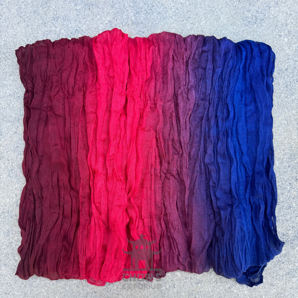 Folded Bloom pirate sash showing blue, bright red and dark red gradient