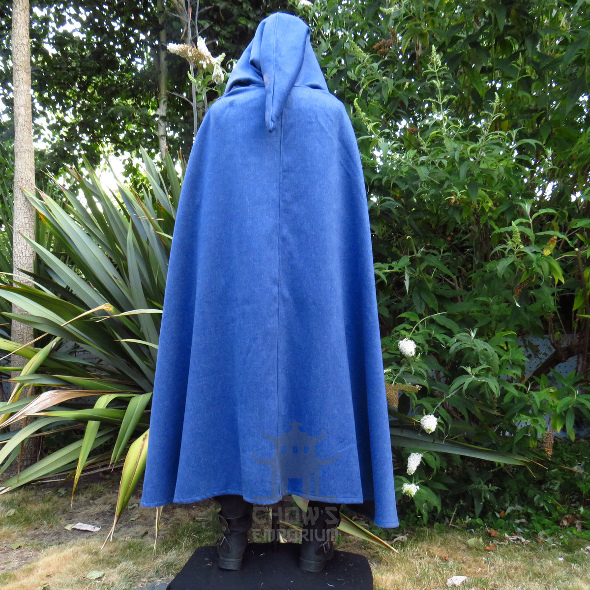 Blue wool hooded cloak worn closed with the deep hood pulled up, front view