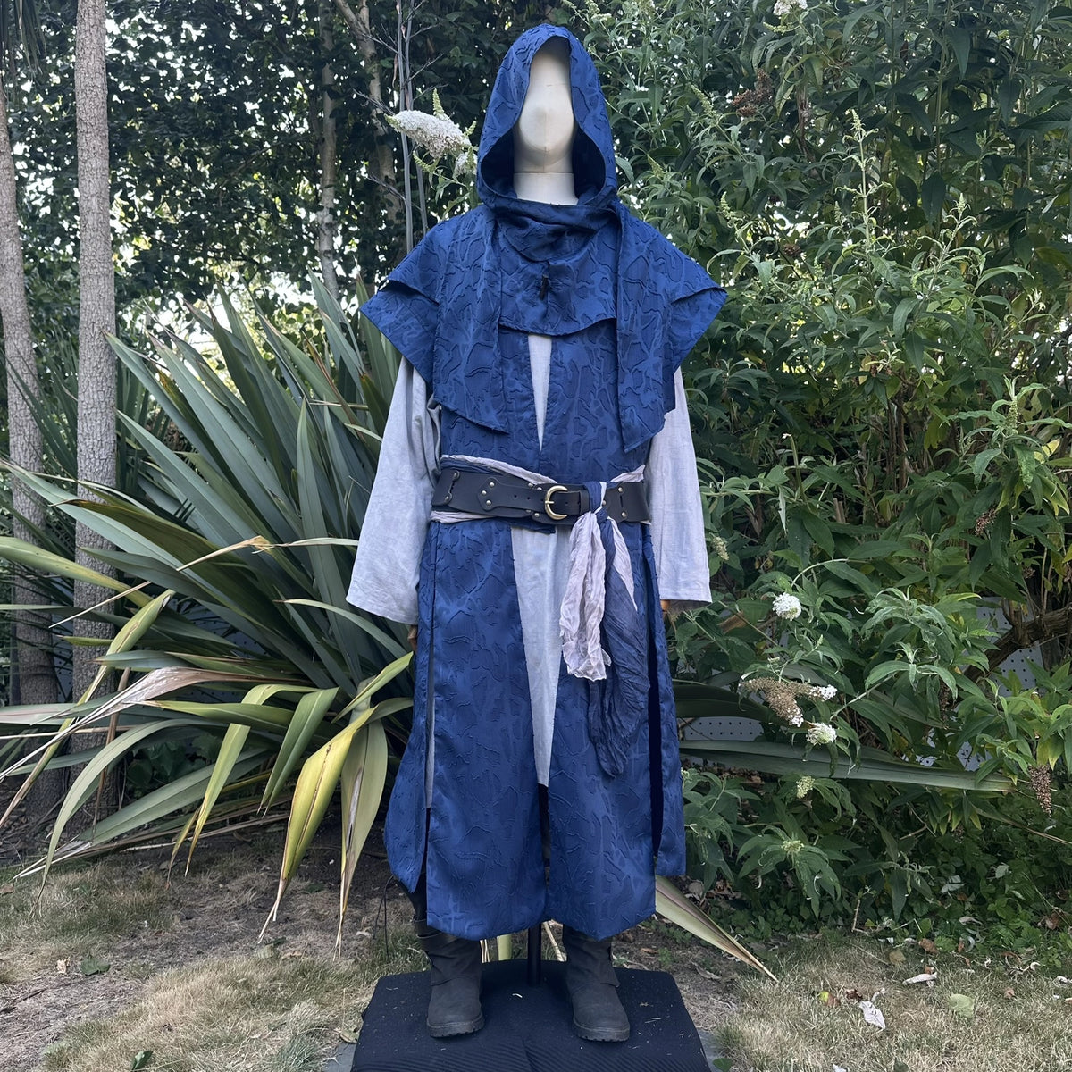 Blue waistcoat and hood set with the hood worn up, front view. Shirt and belt sold separately.