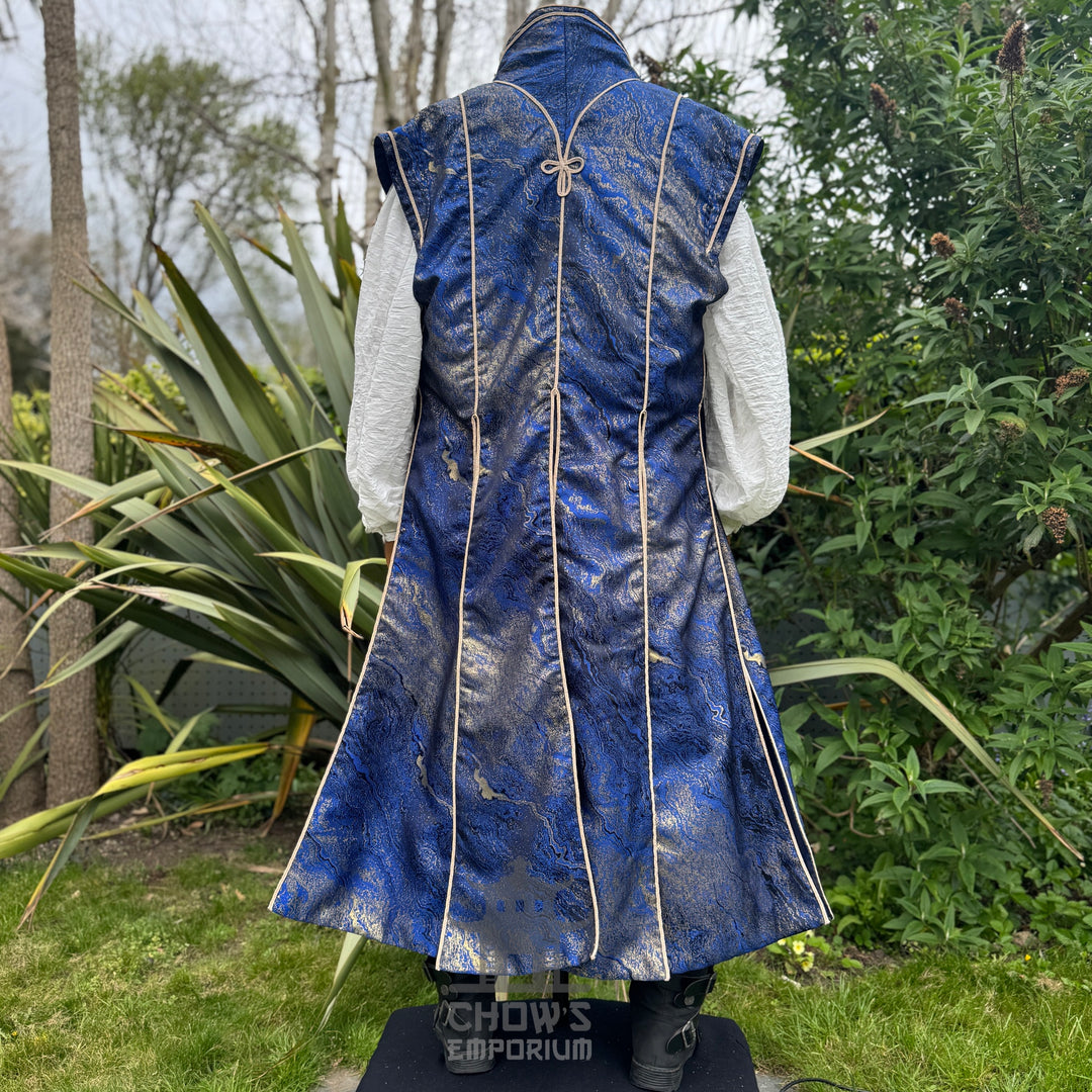 Full-length back view of the blue and gold marble waistcoat and white shirt, sorcerer costume for LARP and ren faire
