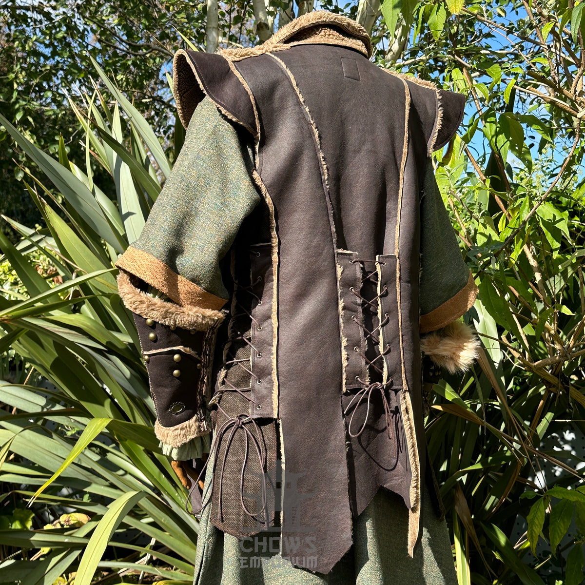 Medieval LARP outfit, brown waistcoat rear view, green robe, leather vambraces.