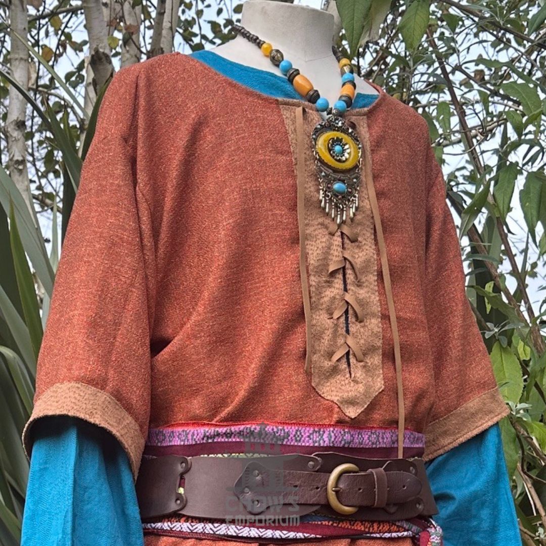 Rust tunic with blue under tunic, brown belt, medieval LARP style.