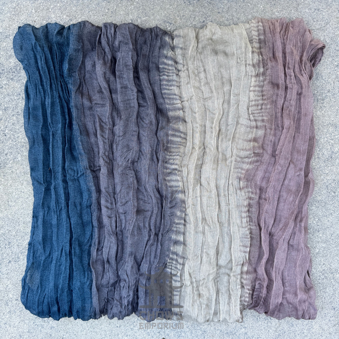 Folded Drift pirate sash showing blue, grey, beige and mauve blend