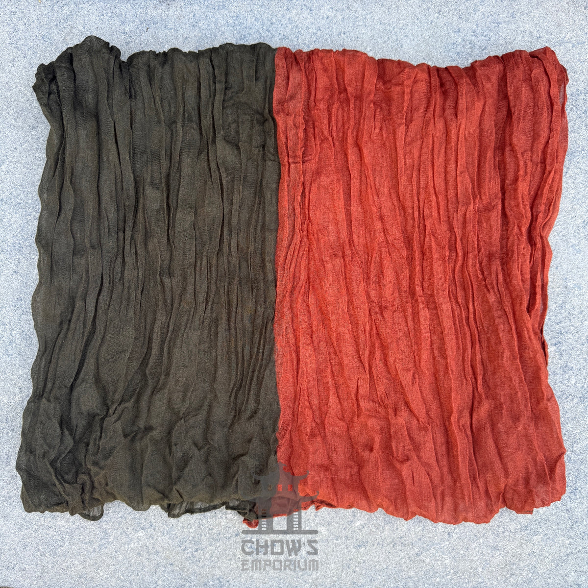 Folded Emberwood pirate sash showing rust and olive green two-tone