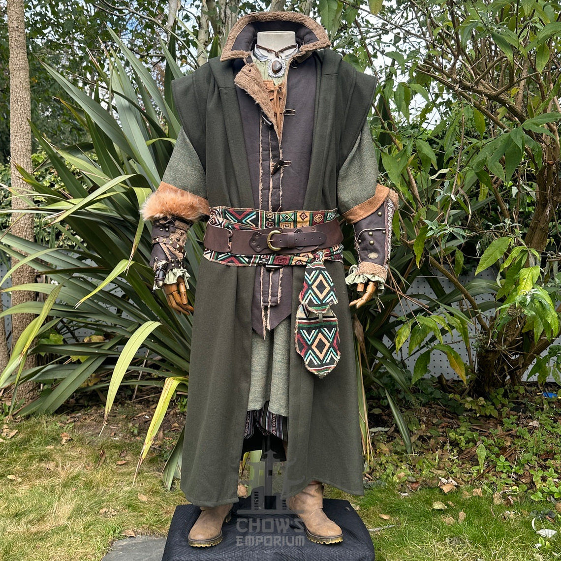 Angle shows medieval LARP outfit with fur-trimmed vambraces and patterned sash.