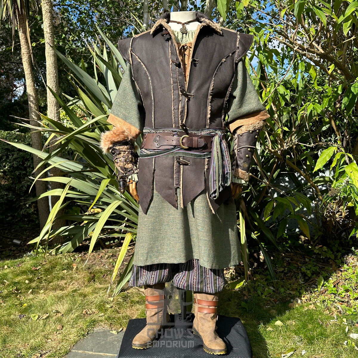 Medieval LARP outfit displayed in garden, focus on layered textures and vambraces.