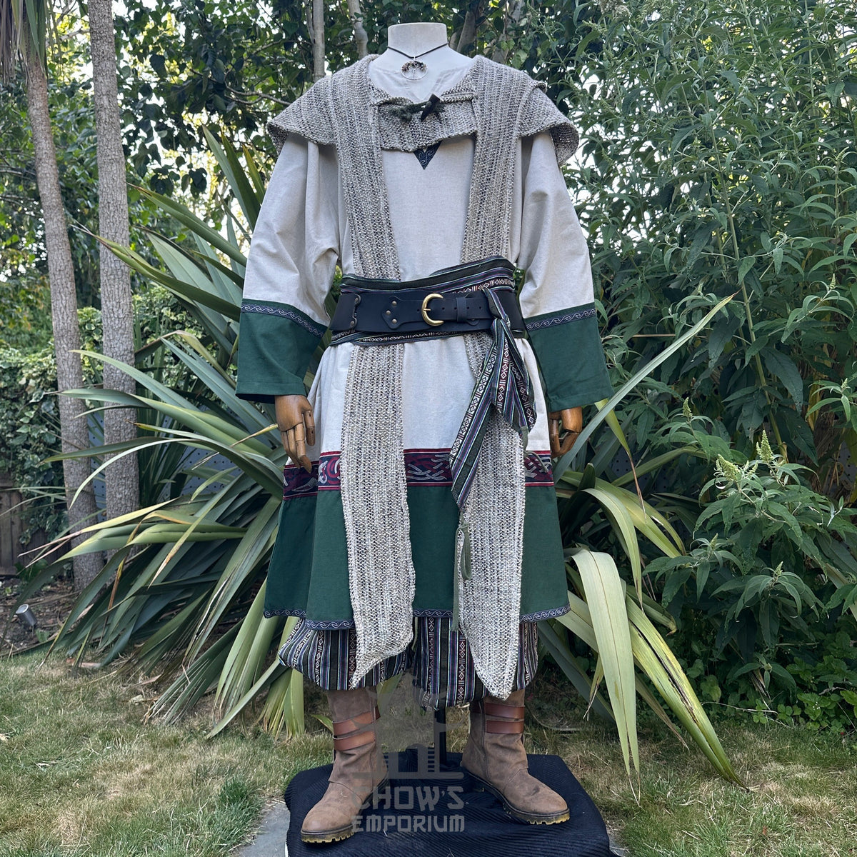 Medieval LARP outfit with textured scarf, garden backdrop, front view.