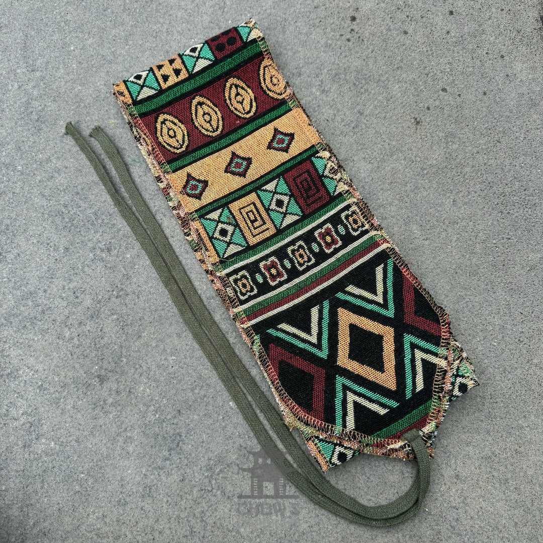 Medieval LARP sash with colorful geometric patterns on grey background.