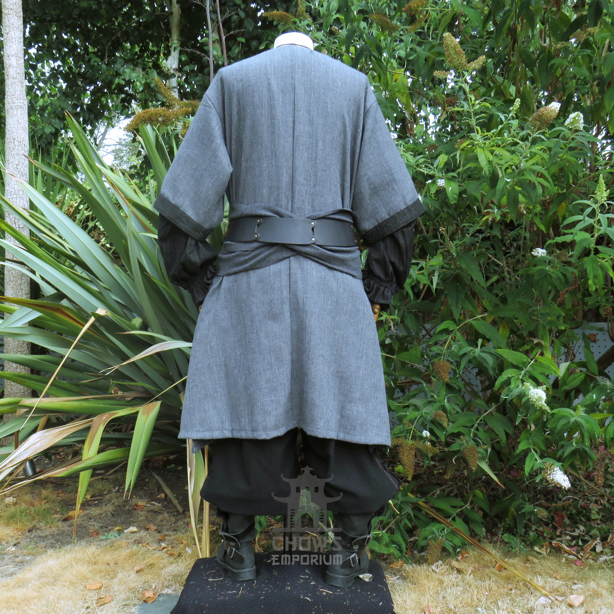 Grey woven medieval tunic from the back, black panel down the centre and a tied sash at the waist. Sash sold separately.