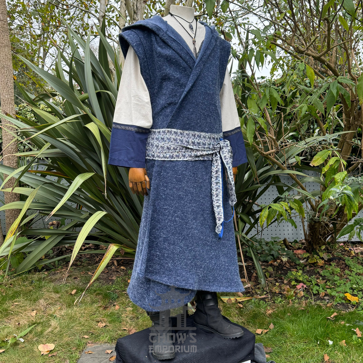 Mannequin wearing a blue robe with a white and blue shirt in an outdoor setting.
