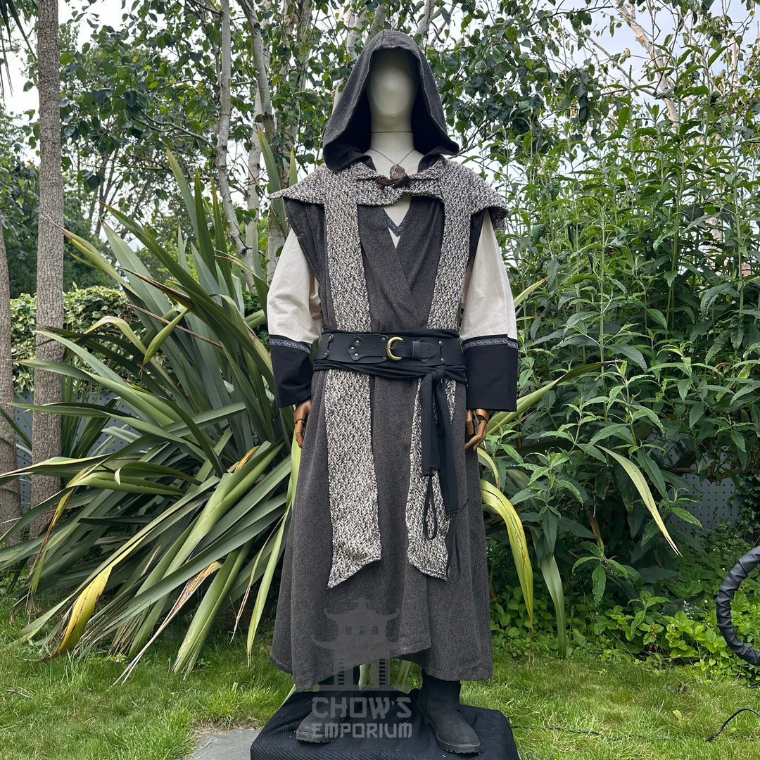 Front view of mannequin in hooded brown herringbone sleeveless robe with scarf hood, in garden setting.