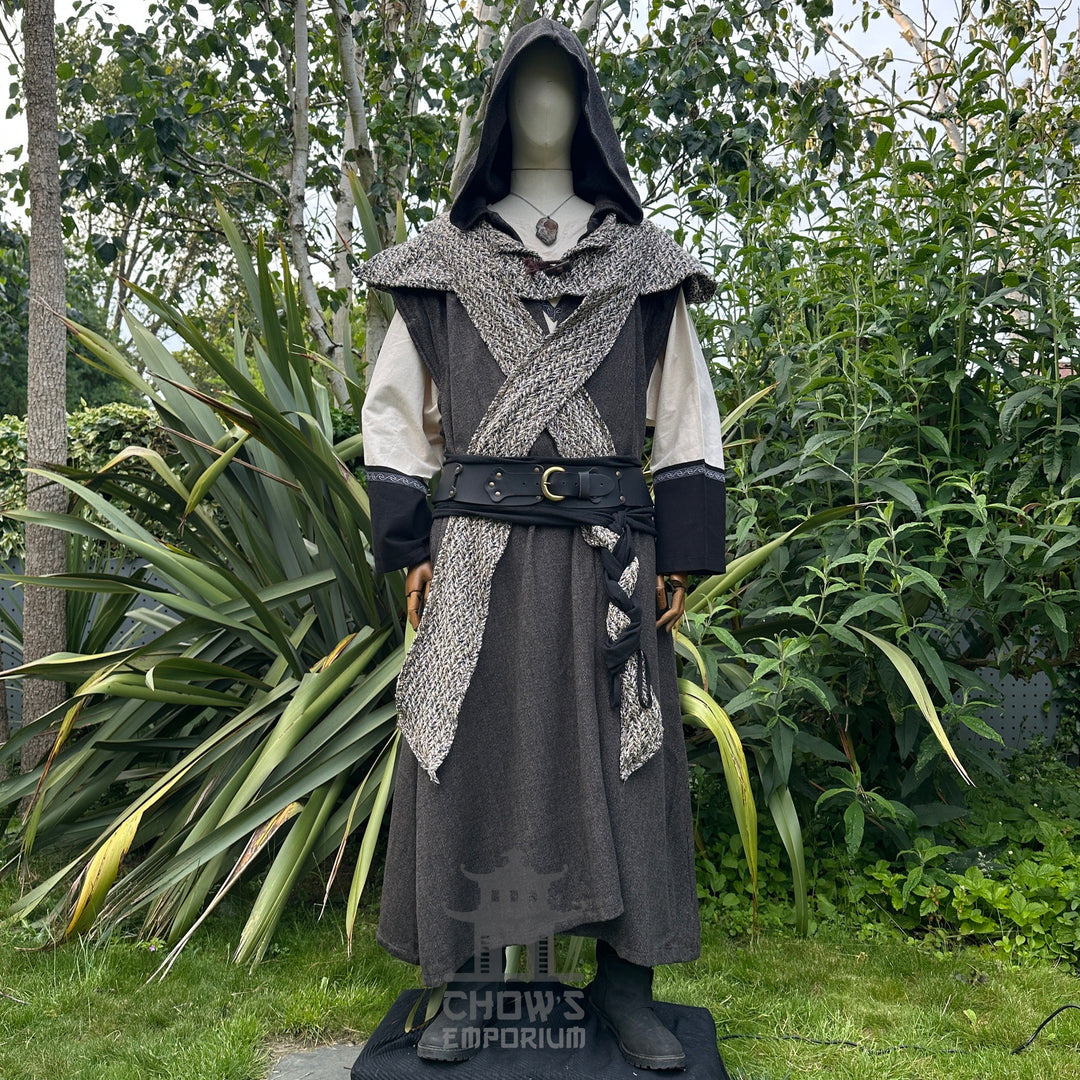 Mannequin in hooded brown herringbone sleeveless robe with scarf hood, in garden setting.