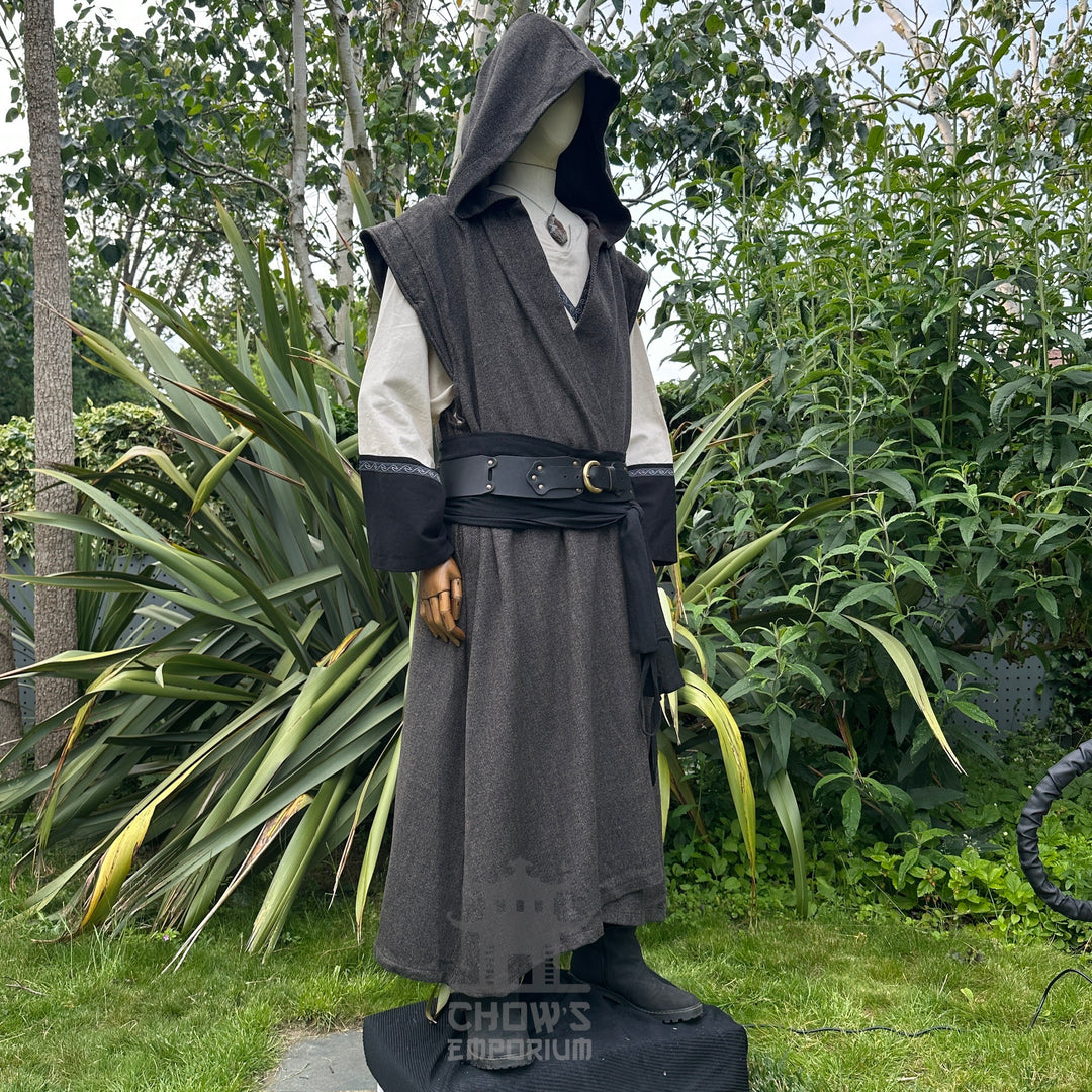 Side view of brown herringbone wool sleeveless robe, shown on mannequin in outdoor setting.