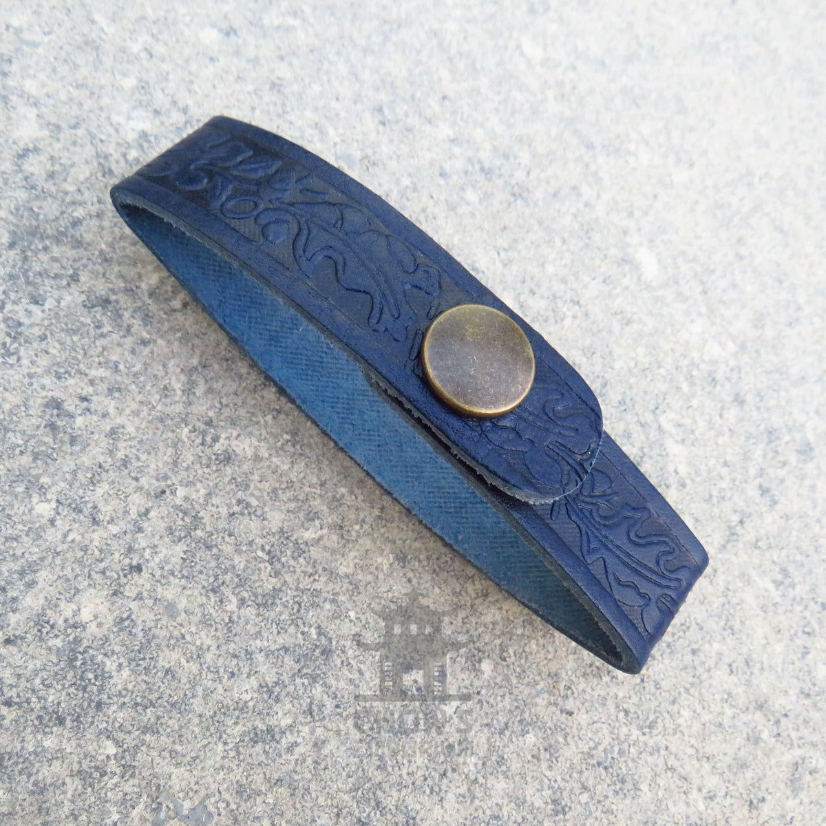 Navy leather tankard loop fastened around a belt, tankard hanging