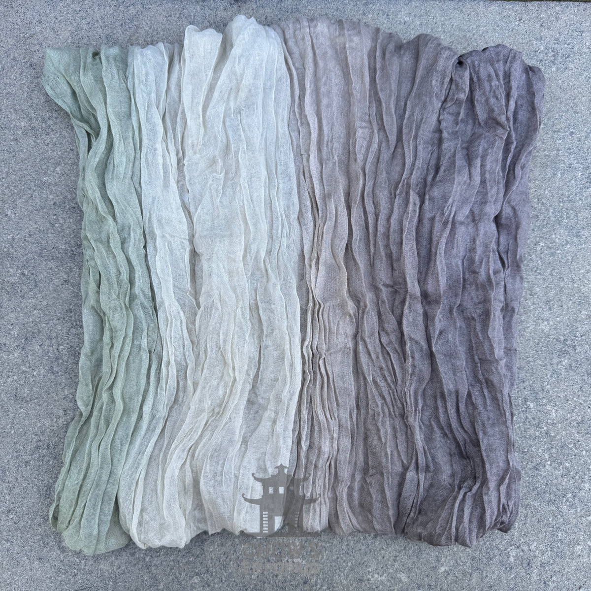 Folded Mist pirate sash showing muted grey, beige and green tones

