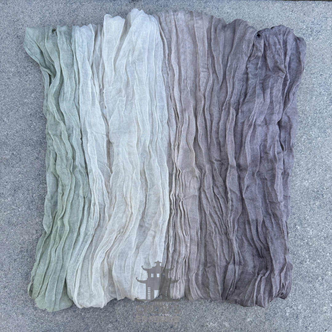 Folded Mist pirate sash showing muted grey, beige and green tones
