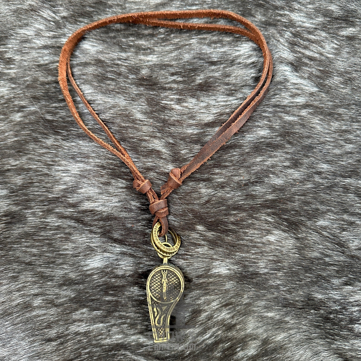 Brown leather whistle necklace with intricate metallic design for LARP events.